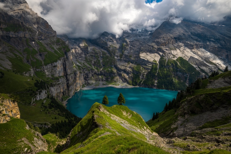 Turquoise Lake in the Swiss Alps with Mountains and Clouds