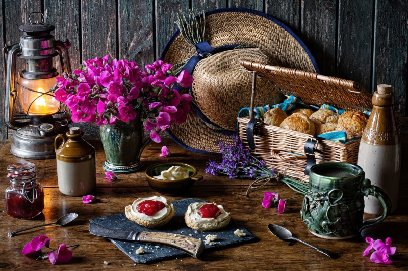 Picnic still life with scones, jam, and buns