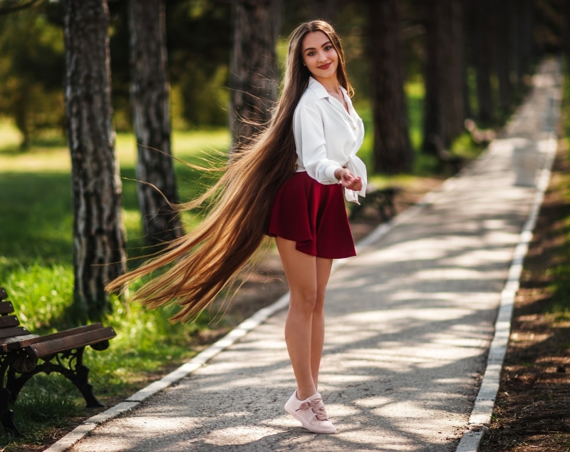 Woman with long brown hair in a park