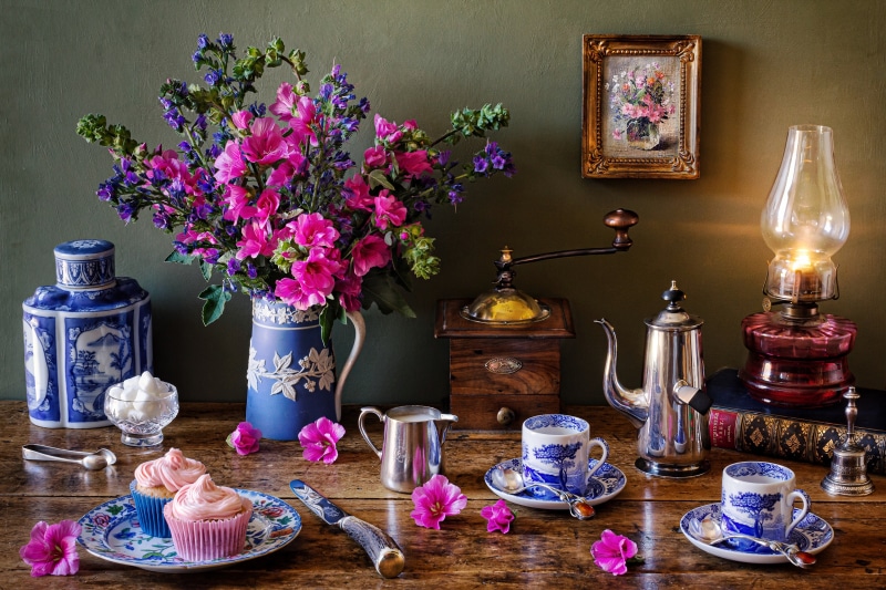 Still-life with flowers, cupcakes, and coffee set