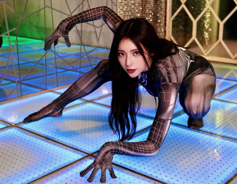 Woman in Spiderman costume posing on a light-up floor