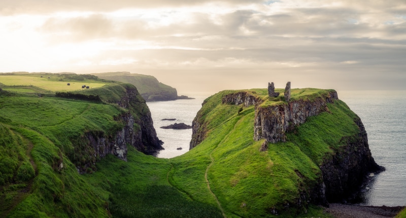 Ruins of a castle on a cliff overlooking the sea in Northern Ireland