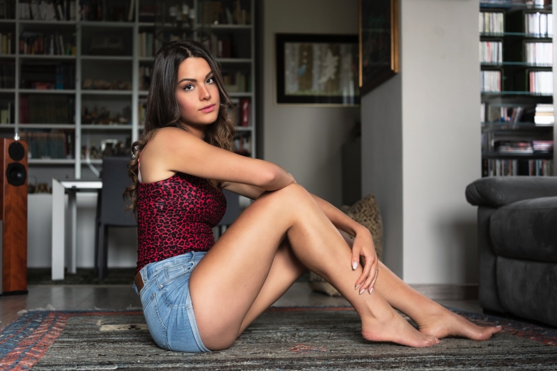 Noemi sitting on a rug in a room