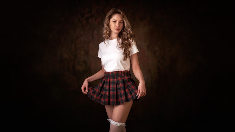 Woman in T-shirt and Plaid Skirt
