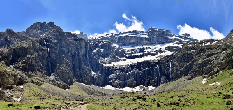 Panorama of waterfalls cascading down snowy mountains in Occitanie, France