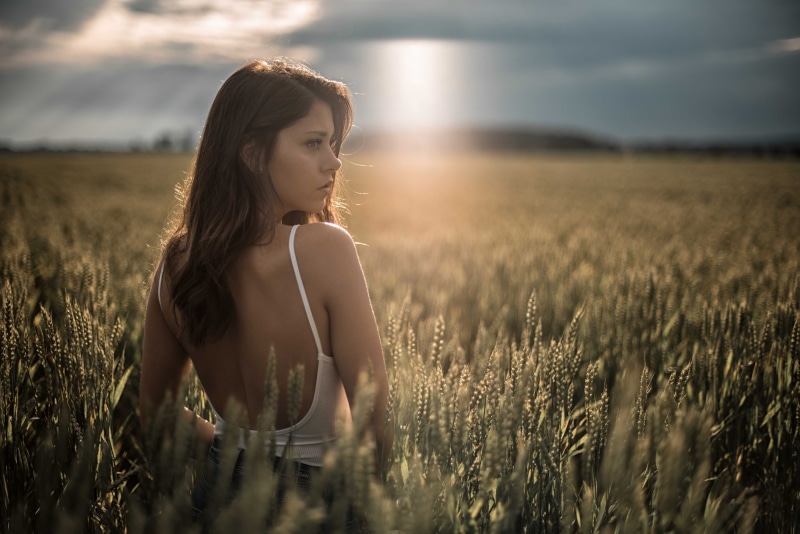 Woman in a wheat field at sunset