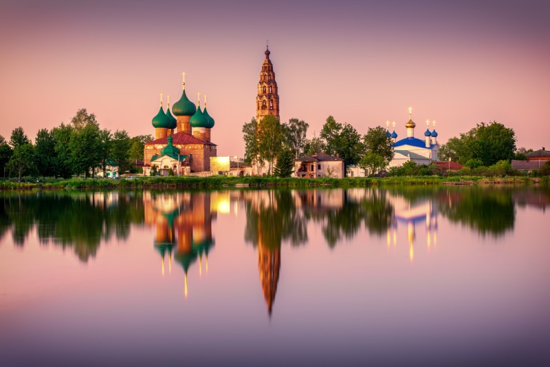 Churches reflected in water at sunset in Yaroslavl region, Russia