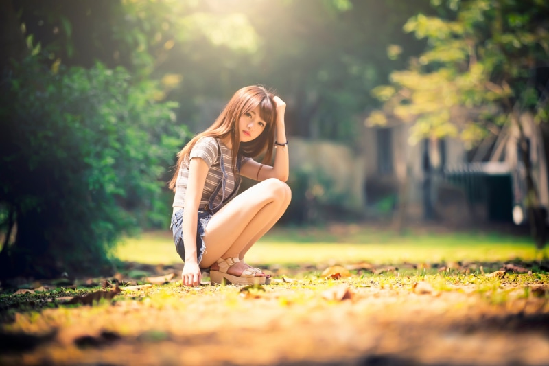 Asian Bokeh Side Brown Haired Hands Pose Shorts Legs Sitting