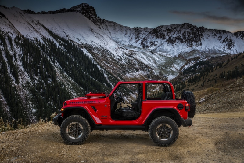 Red Jeep Wrangler Rubicon in Snowy Mountains