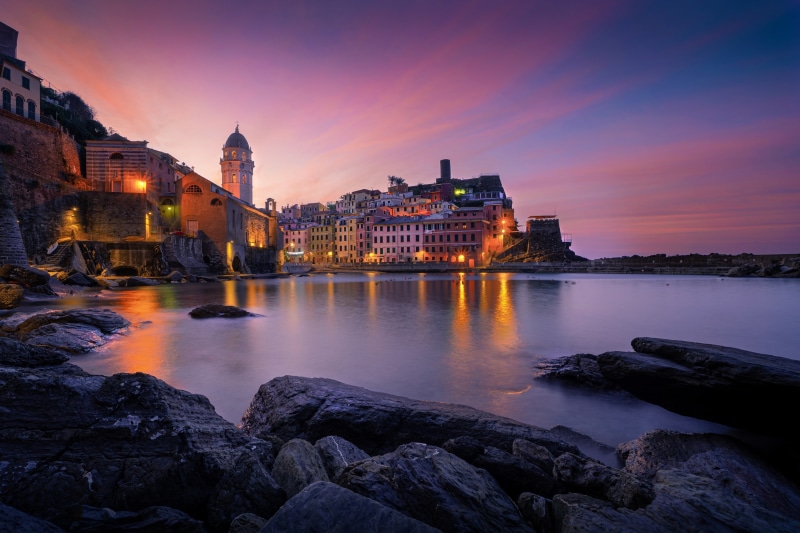Vernazza, Italy at dusk with colorful sky and reflections