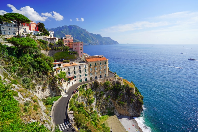 Houses on a cliffside road overlooking the sea in Atrani, Italy