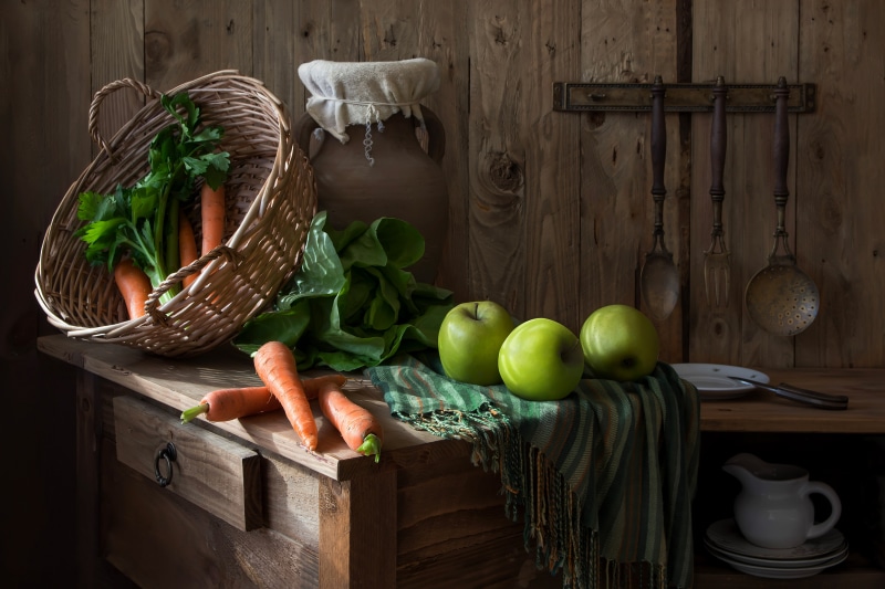 Still-life with apples, carrots, and wicker basket