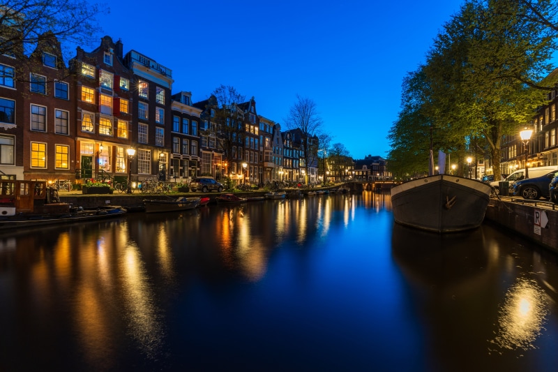 Amsterdam Canal at Dusk with Houses and Boats