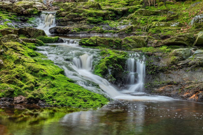 Waterfalls and moss-covered rocks in Les Arsins, Belgium