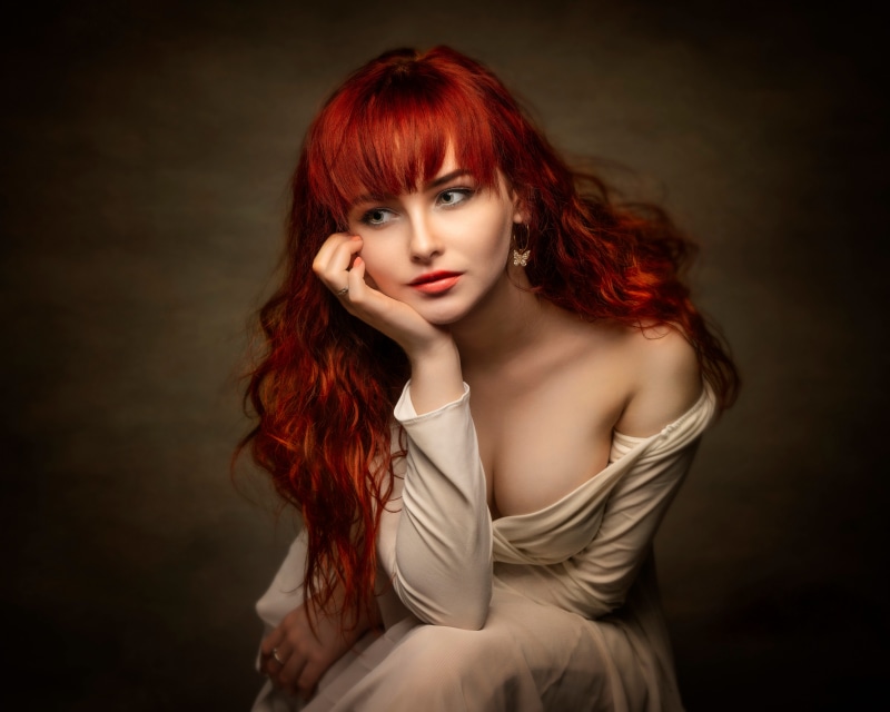 Redhead girl Jagoda sitting in a dress