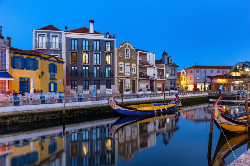 Moliceiro boats on a canal in Aveiro, Portugal at dusk