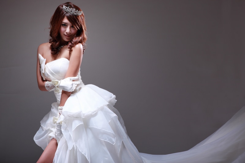 Bride in white dress with tiara and gloves