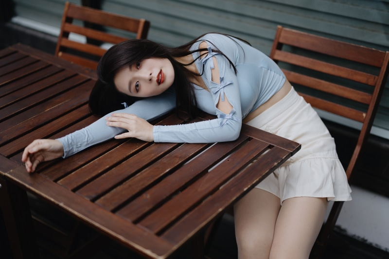 Asian girl with brunette hair sitting at a table