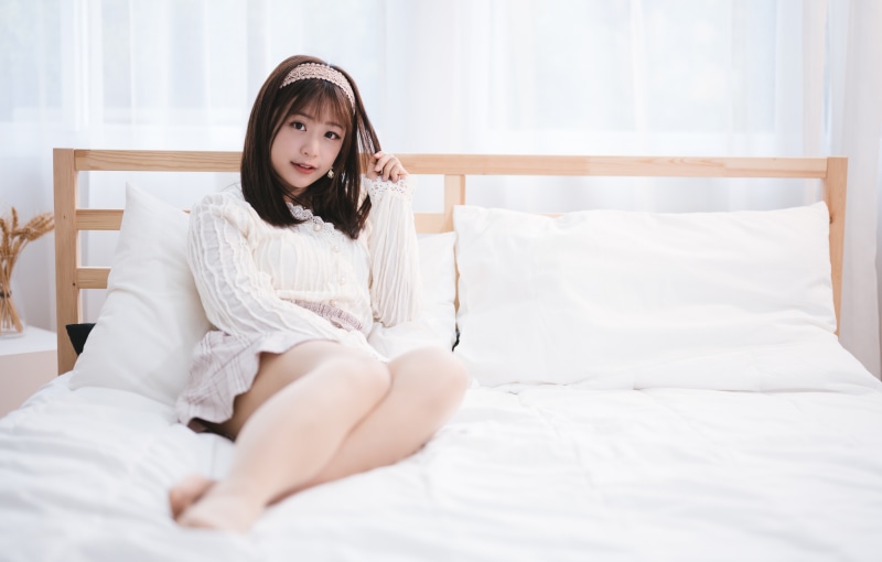 Brunette girl lying on a bed