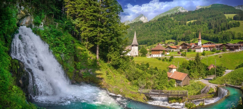 Waterfall and Village in the Alps, Switzerland