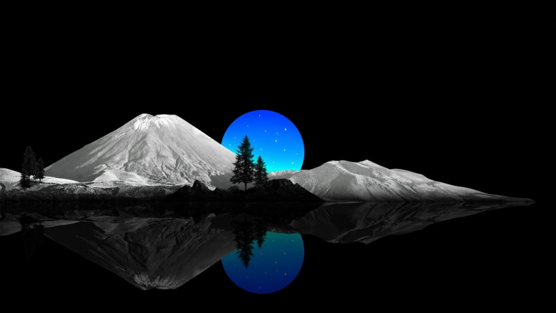 Mountains reflected in water with a blue moon