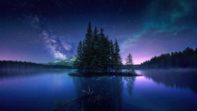 Night sky over lake with trees and mountains 4K