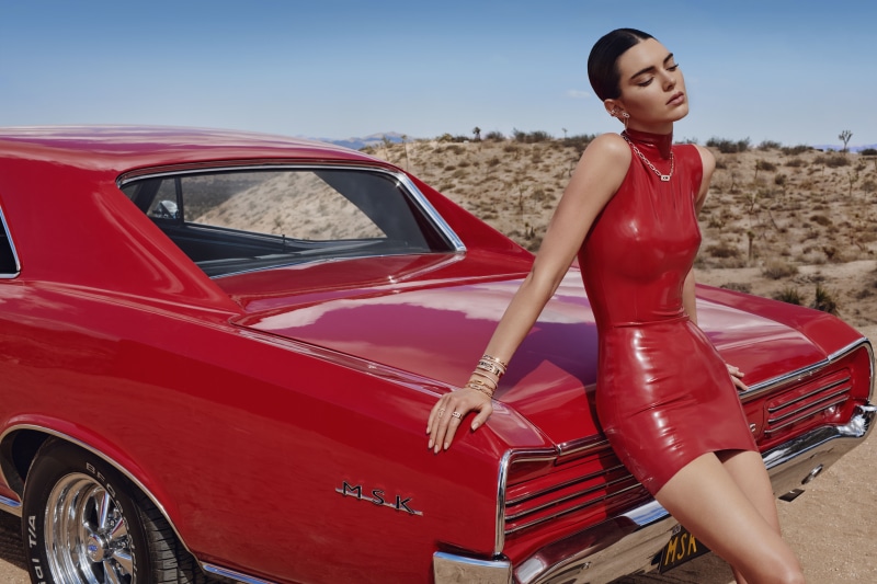 Kendall Jenner in red dress by red car