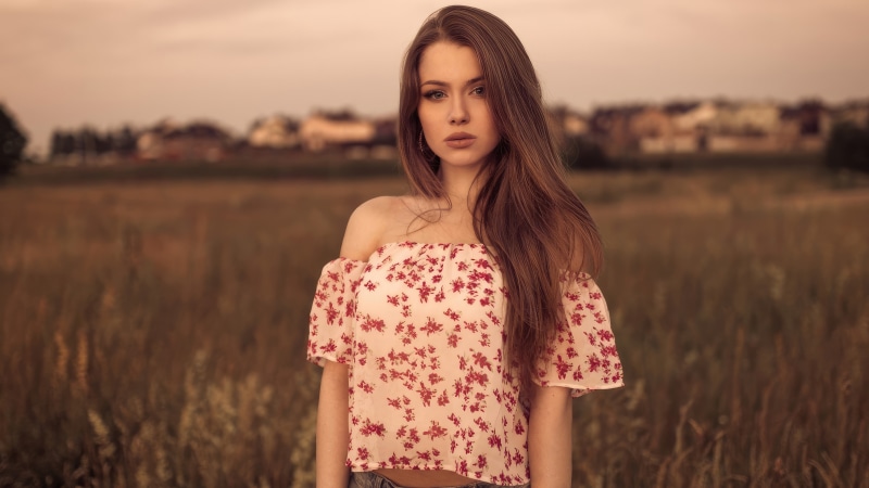 Brunette model in floral top outdoors