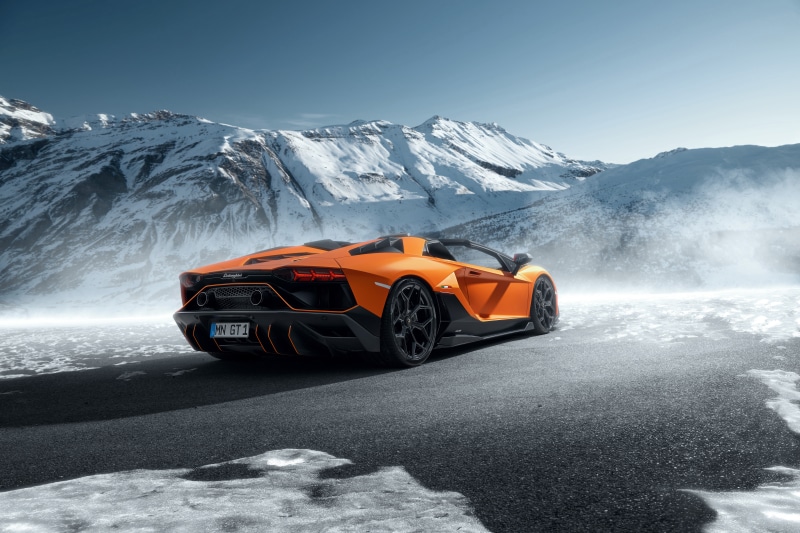 Orange Lamborghini Aventador SVJ Roadster in Snowy Mountains