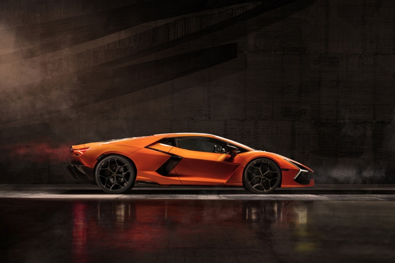 Orange Lamborghini Revuelto in a dark setting