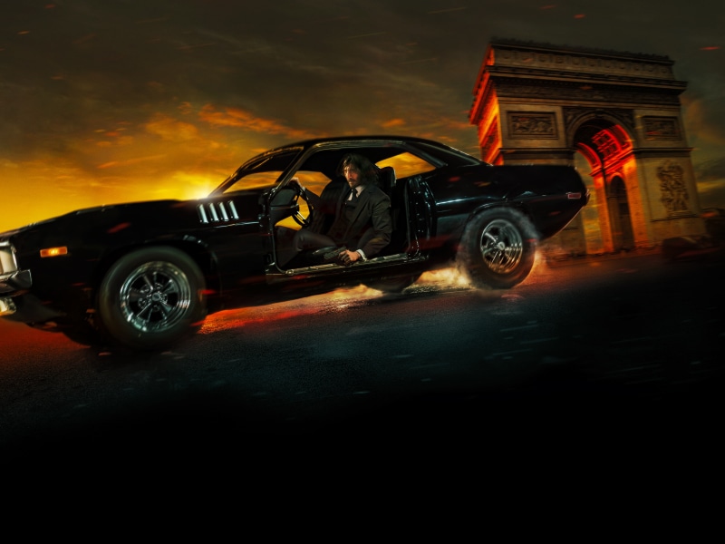 John Wick from John Wick: Chapter 4 driving a car