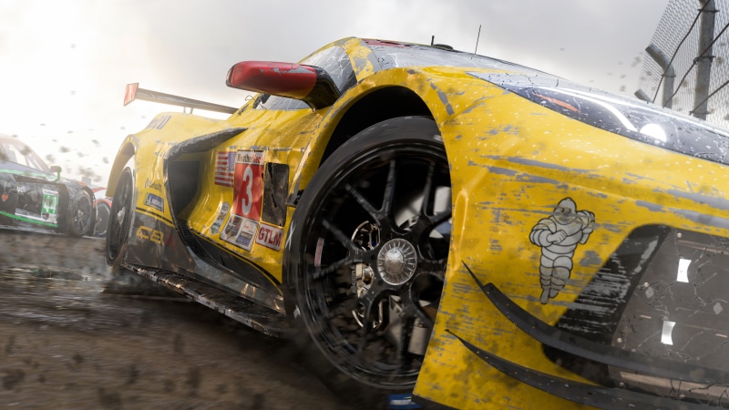 Yellow race car with Michelin man logo on track