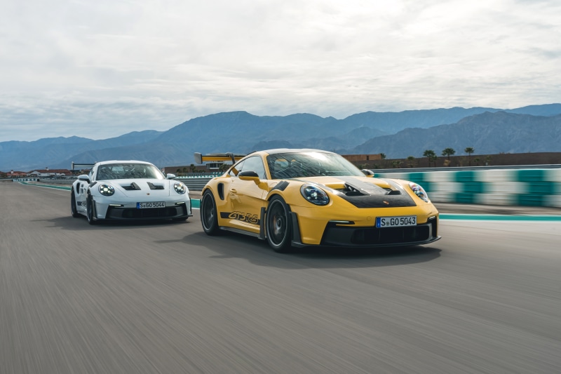 Two Porsche 911 GT3 RS cars on a racetrack