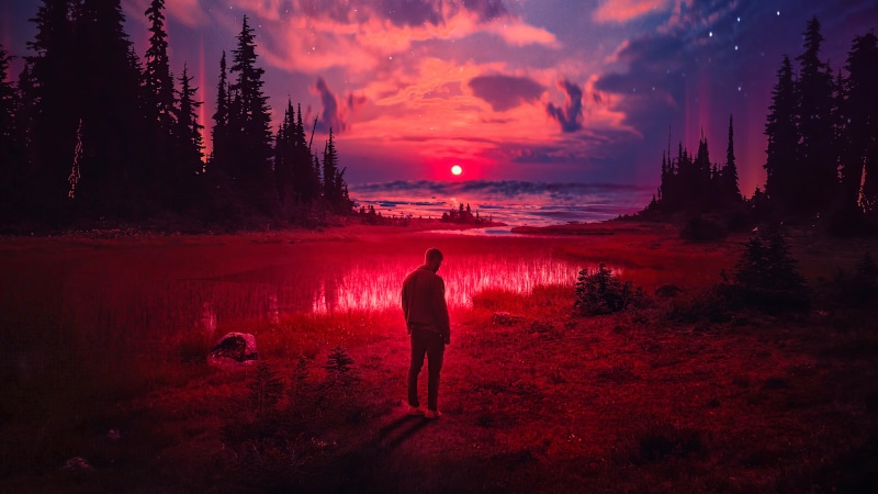 Man standing in a red landscape with a sunset