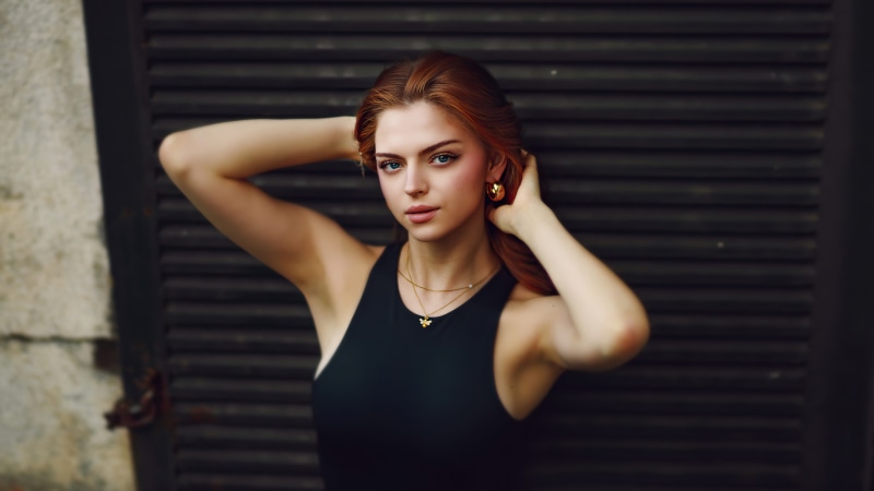 Redhead model with gold earrings and necklace