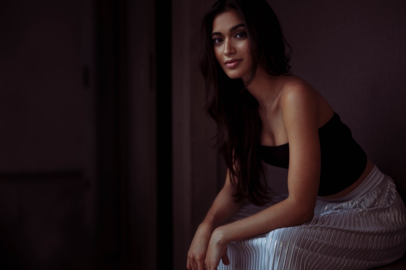Woman in a black top and silver skirt