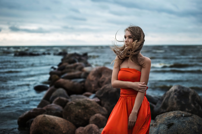 Girl in orange dress by the sea 4K