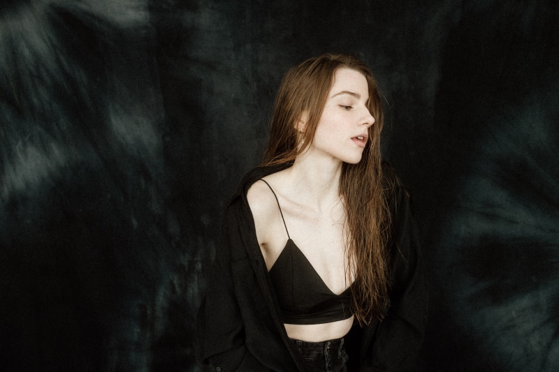 Woman in black bra and open shirt