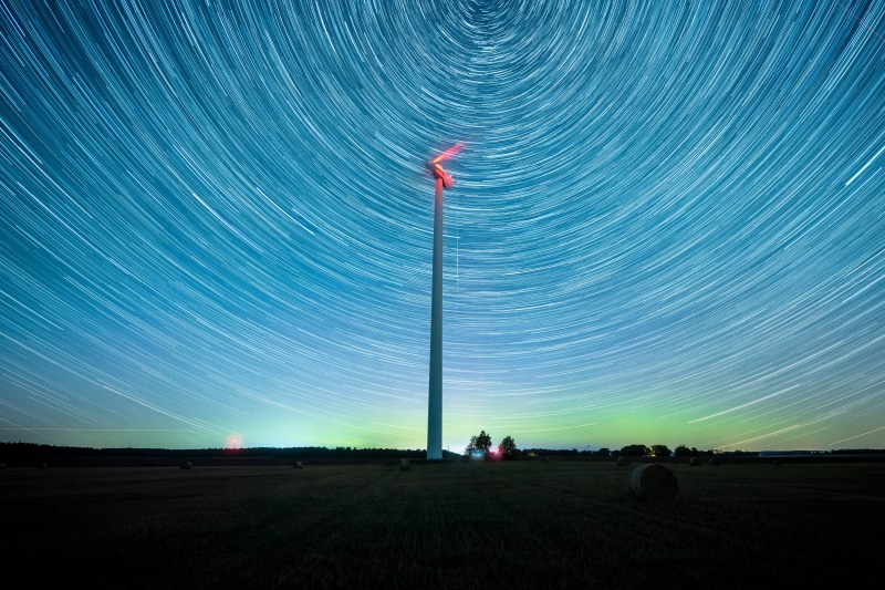 Windmill under star trails and aurora