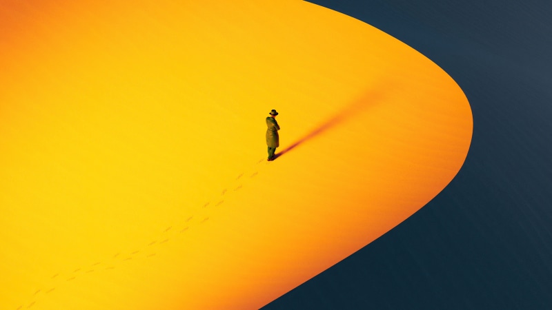 Person in a hat and coat on a yellow surface