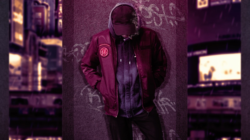 Man in hoodie and bomber jacket with patch