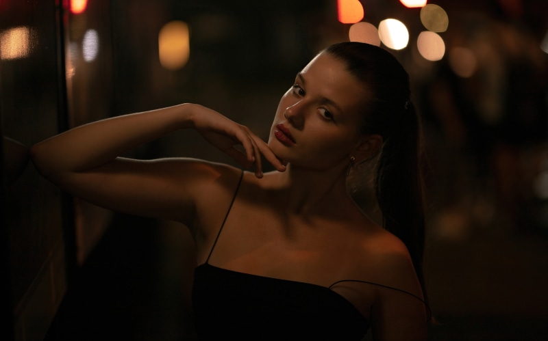 Model in black dress at night