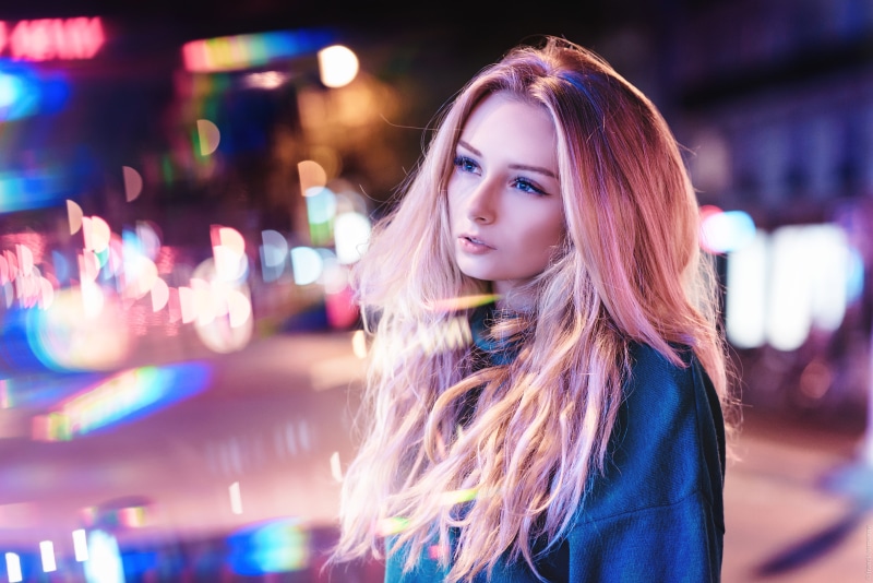 Blonde girl with pink hair in neon city