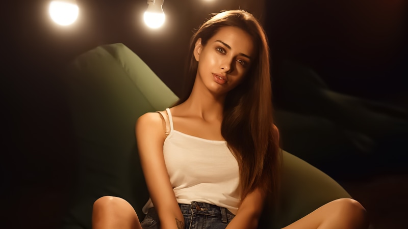 Model in white tank top and denim shorts