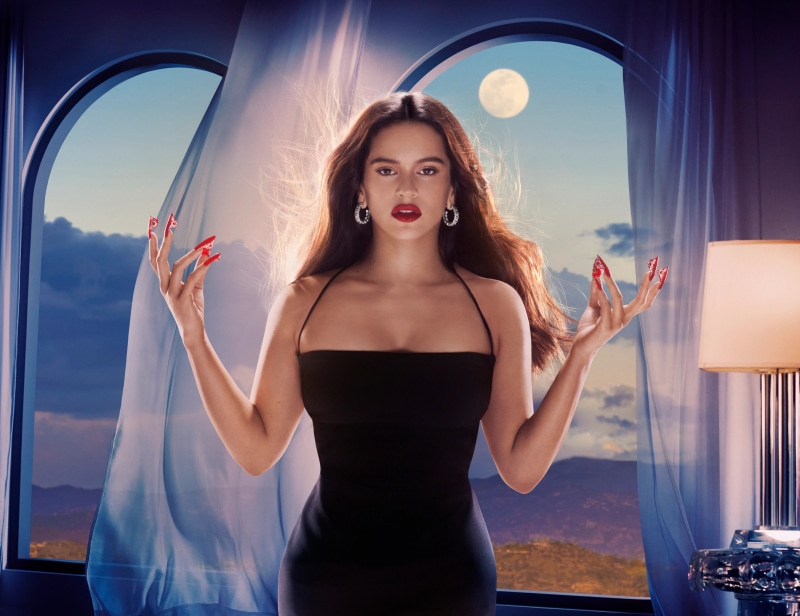 Rosalía in a black dress with long red nails
