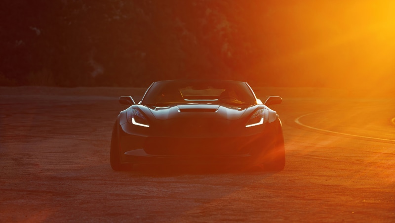 Chevrolet Corvette C7 on a road at sunset