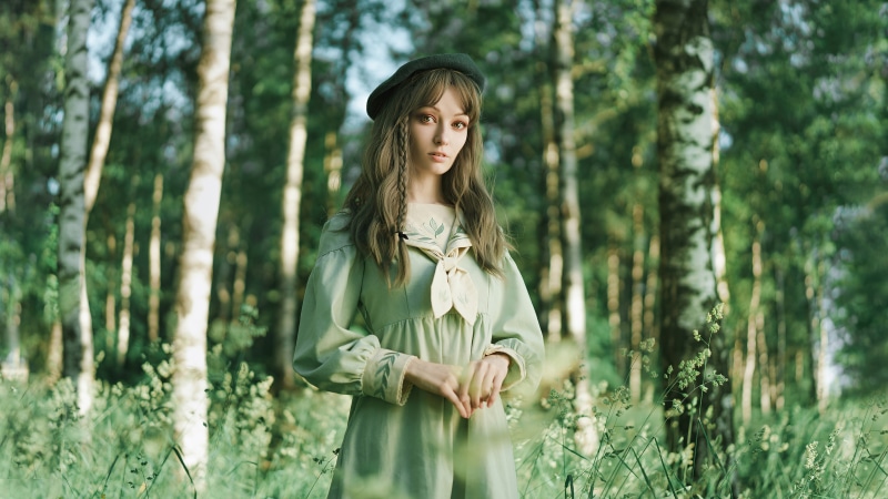 Girl in green dress and beret in forest