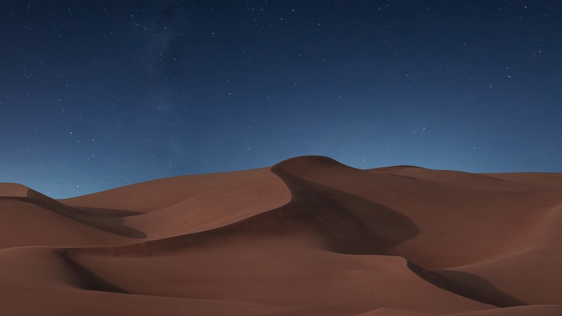Desert dunes under a starry night sky 4K