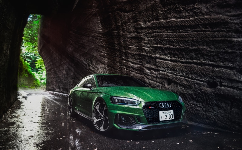 Green Audi RS 5 in a rocky tunnel
