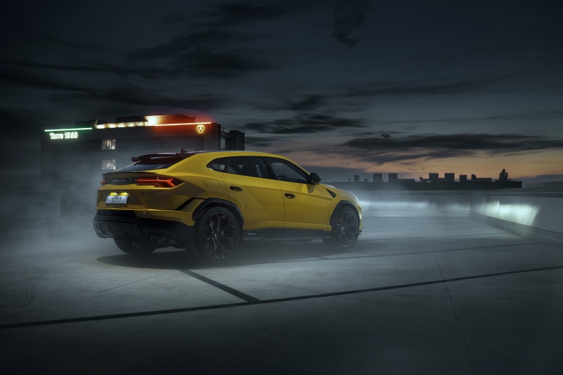 Yellow Lamborghini Urus on a foggy rooftop at night